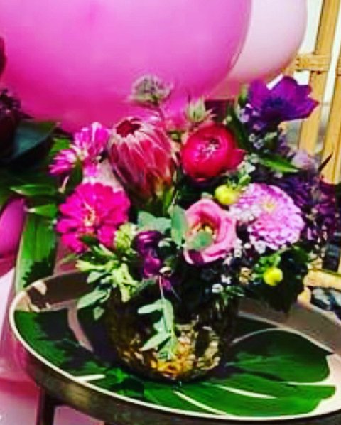 Bright pink arrangement with protea and dahlias