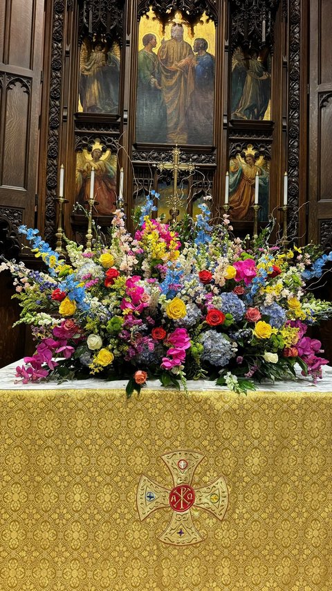 Colorful spring arrangement on a gold altar cloth