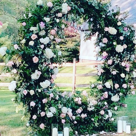 Round arch covered in white and blush roses