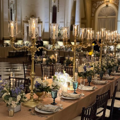 Candlelit reception with gold candelabras and low florals
