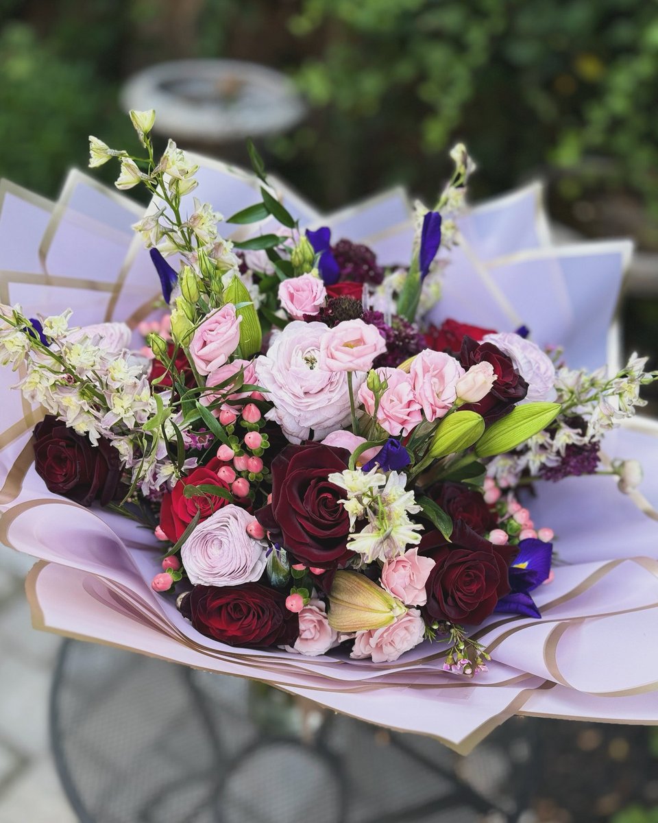 Wrapped bouquet in pink, burgundy, and white