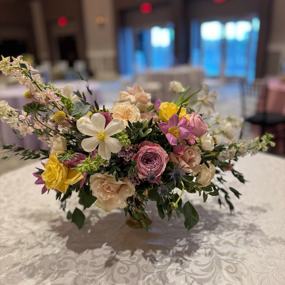 Low garden-style arrangement in soft pastels