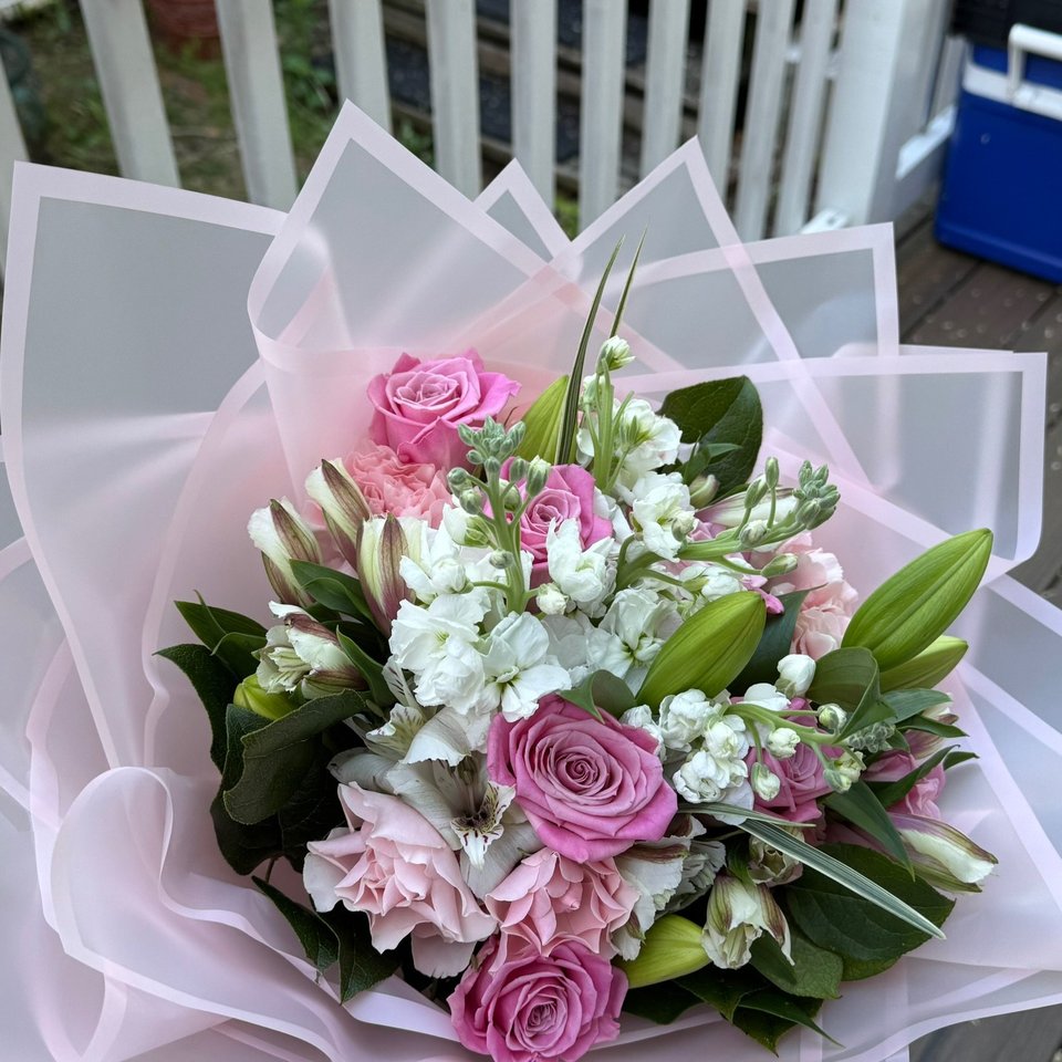 Pink rose bouquet in sheer pink wrap