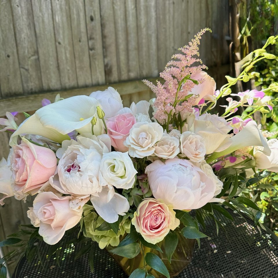 Blush peonies, roses, and calla lilies