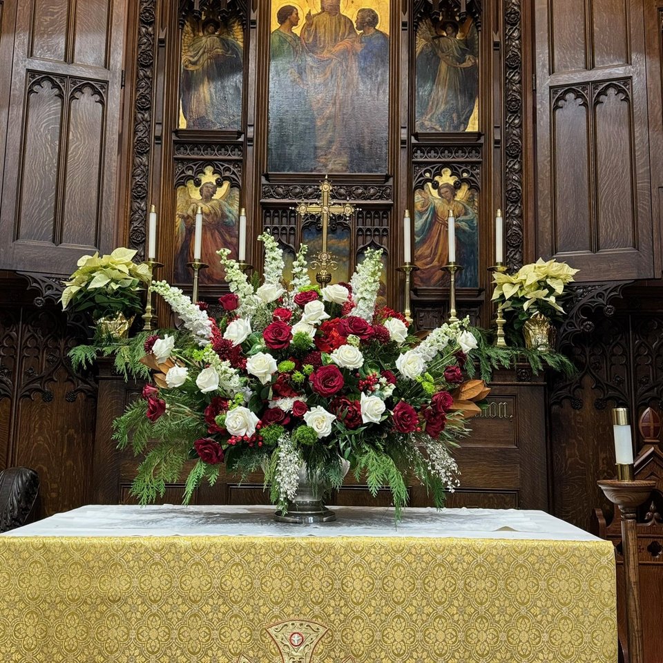 Red and white altar arrangement with lilies
