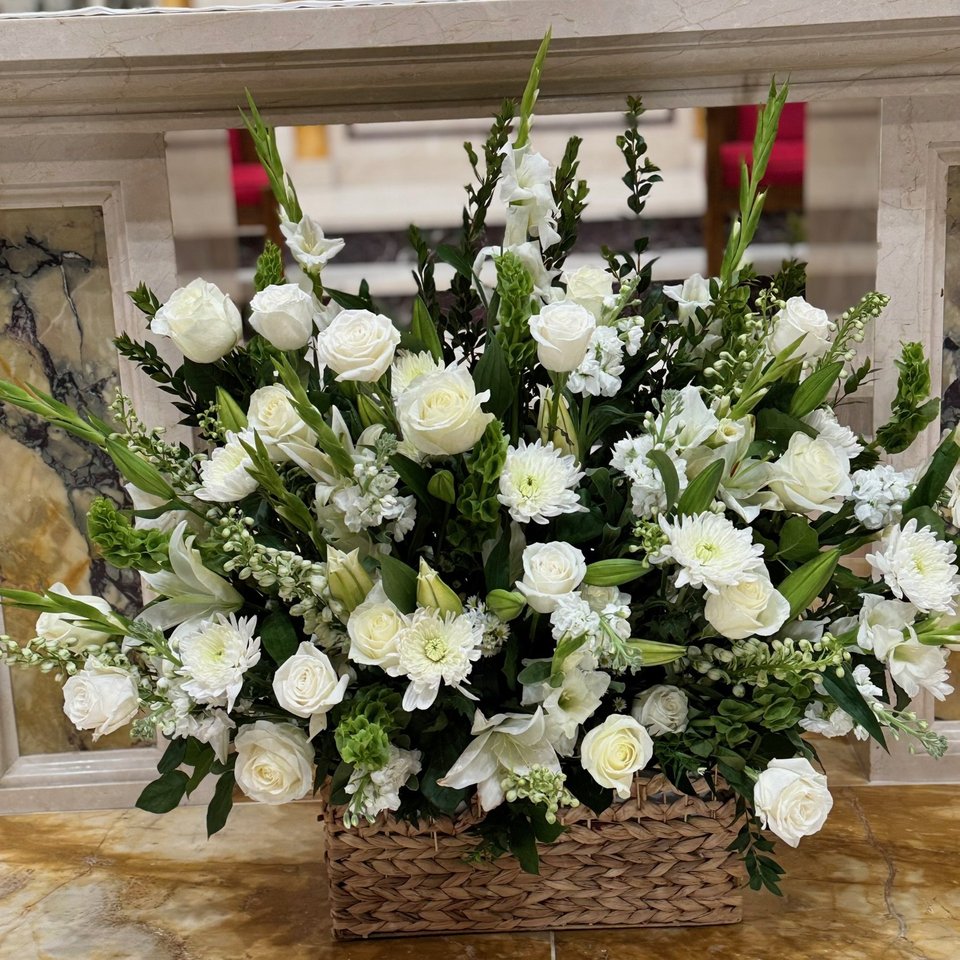White basket arrangement with roses and lilies