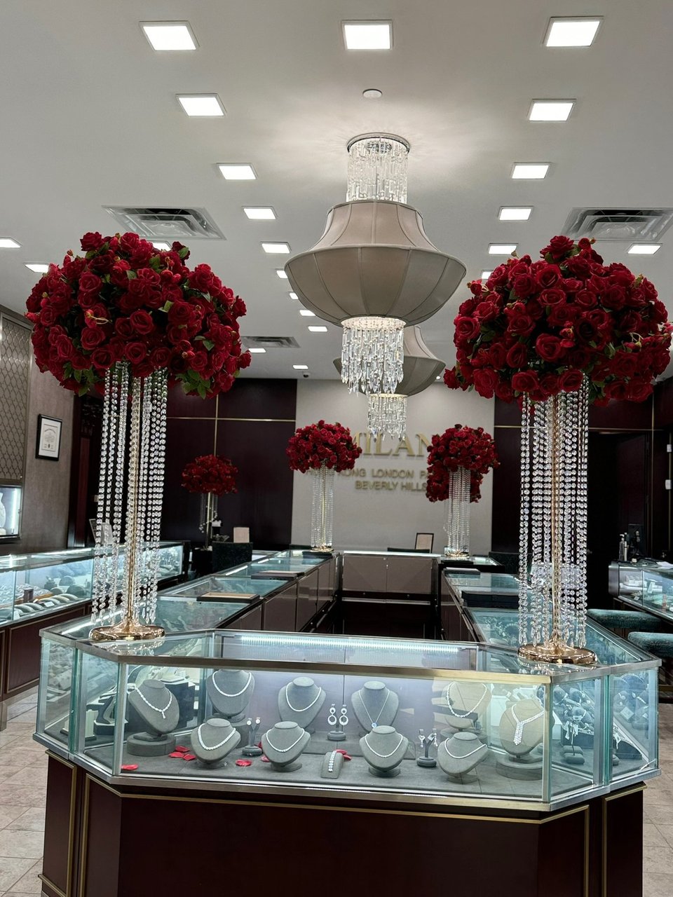 Tall red rose arrangements in a jewelry showroom