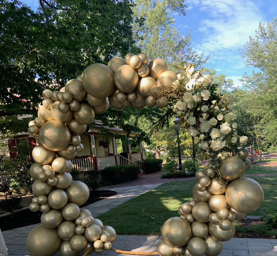 Gold balloon arch in a garden