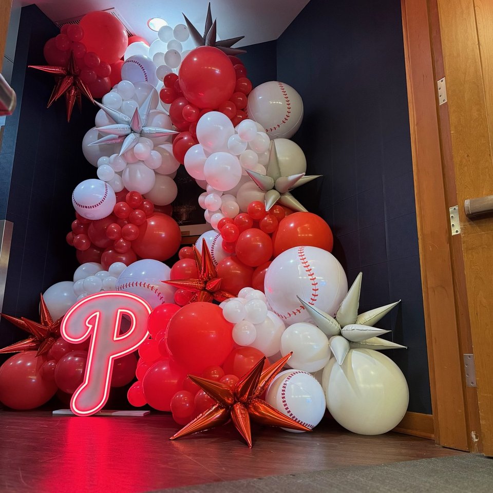 Baseball-themed red and white balloon display