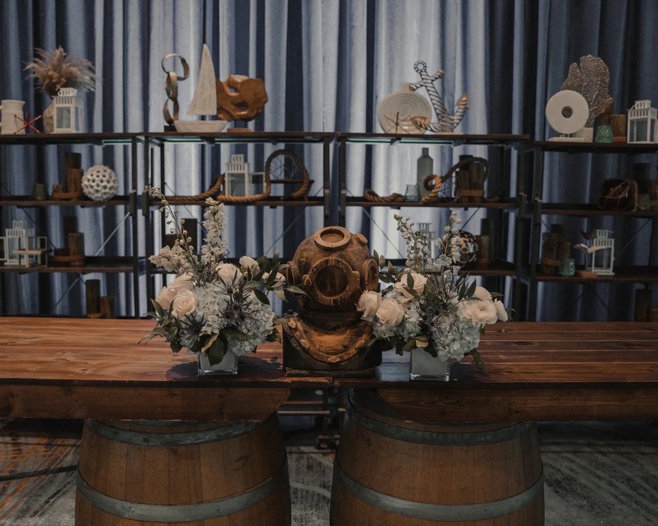 Nautical display with a diving helmet and white flowers