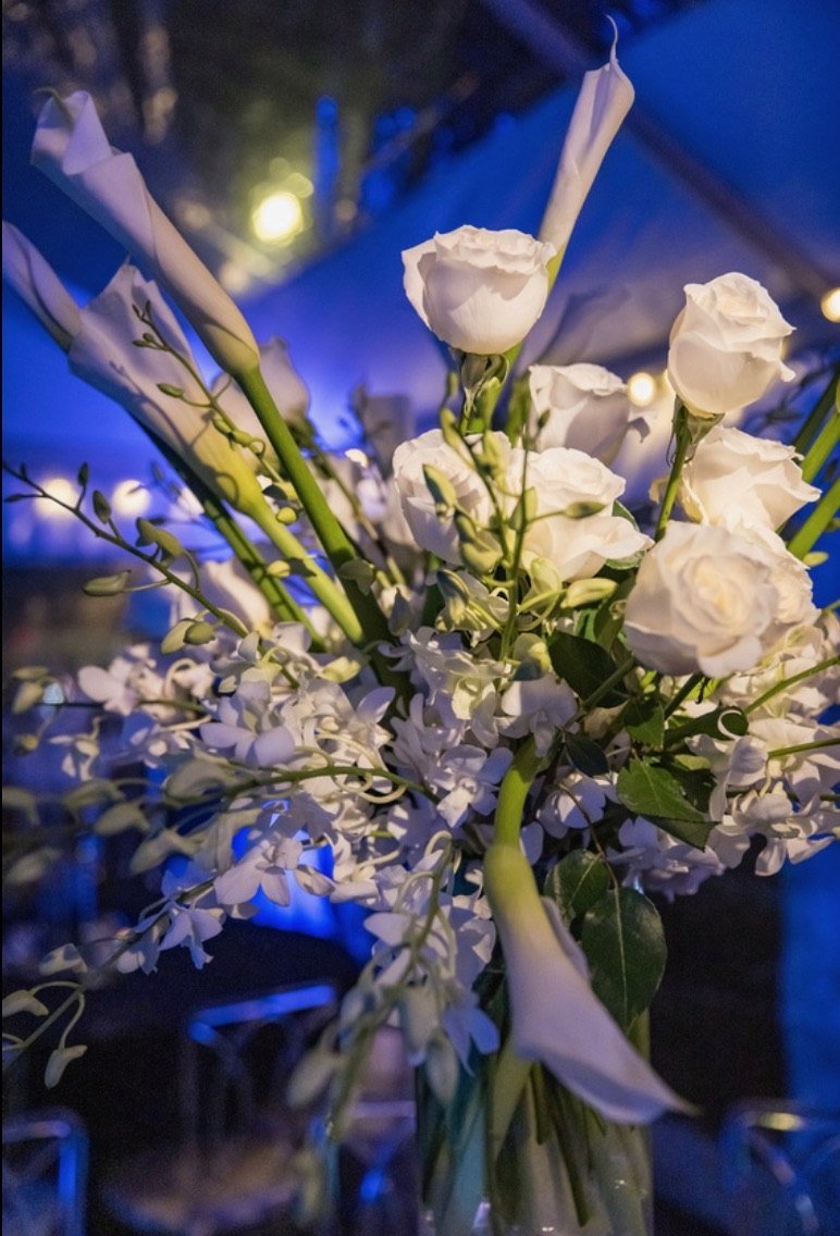 White roses and calla lilies in blue light
