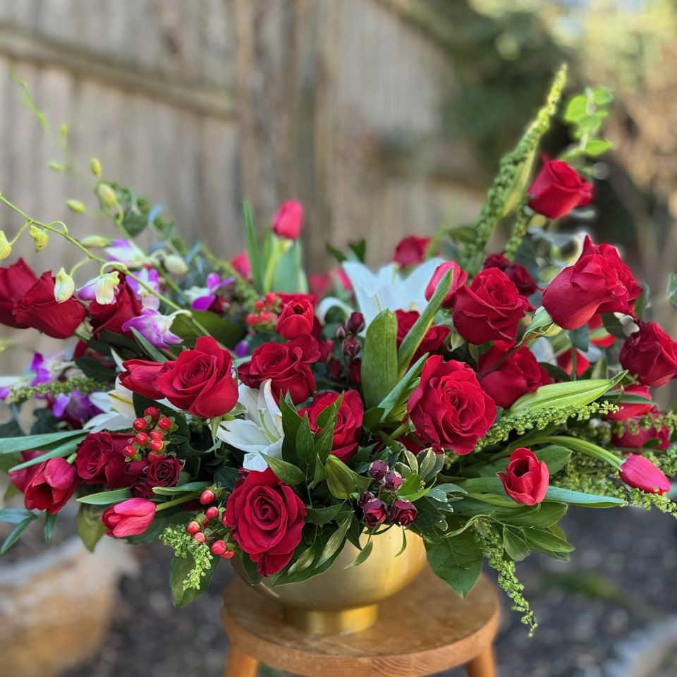 Red roses and white lilies in a gold bowl