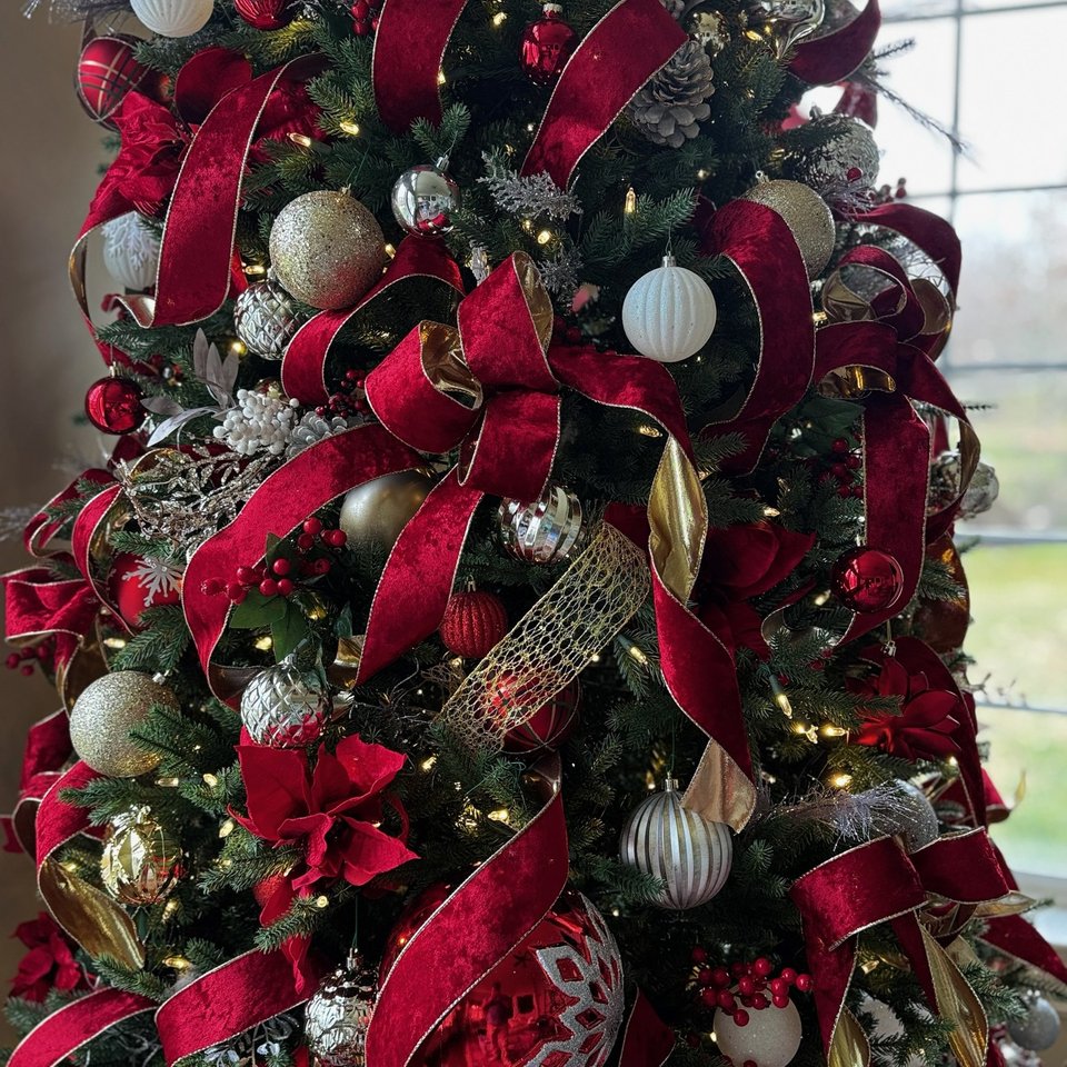 Christmas tree with burgundy ribbon and ornaments