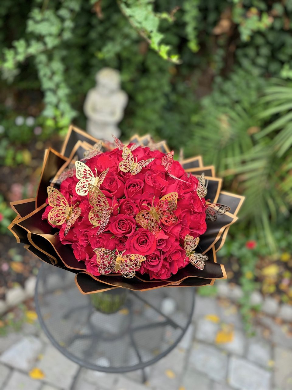 Red rose bouquet with gold butterflies