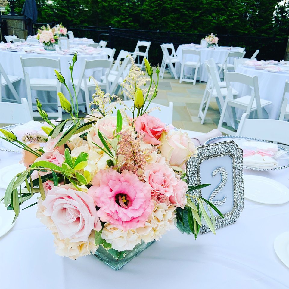 Pink and white centerpiece beside a table number