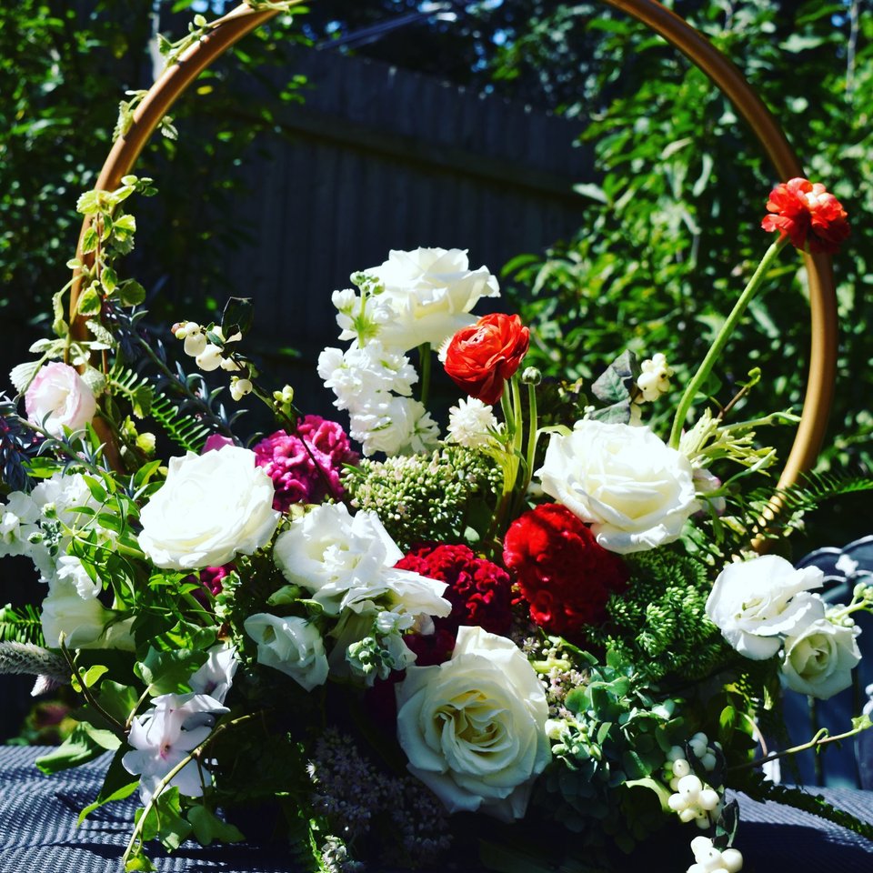 White and red roses at the base of a round arch