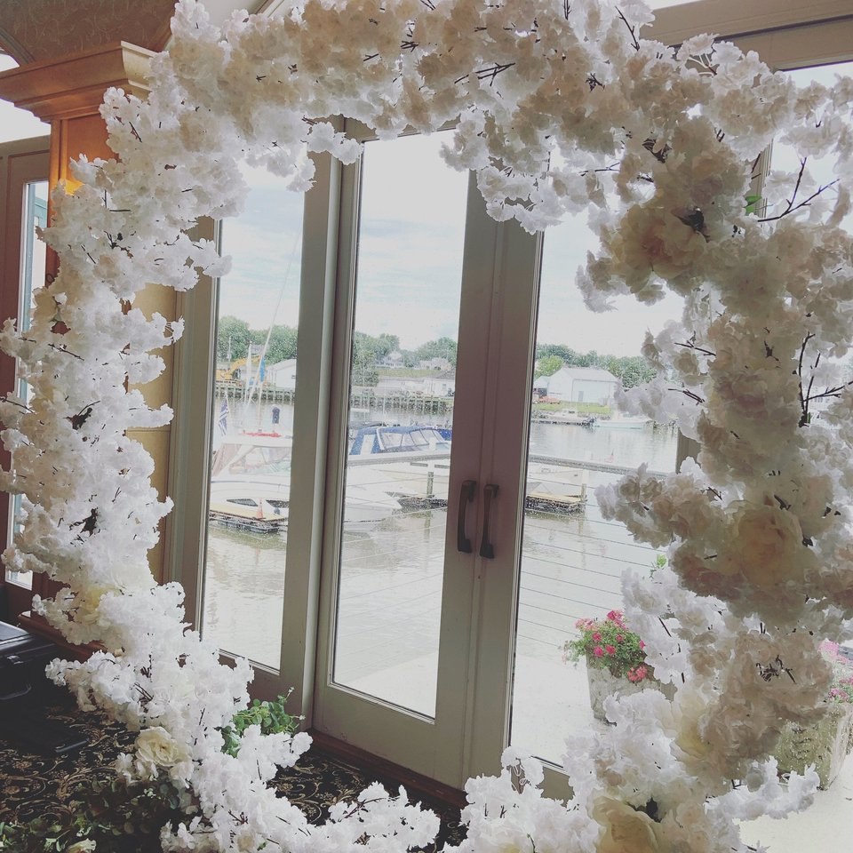 White blossom arch framing a window