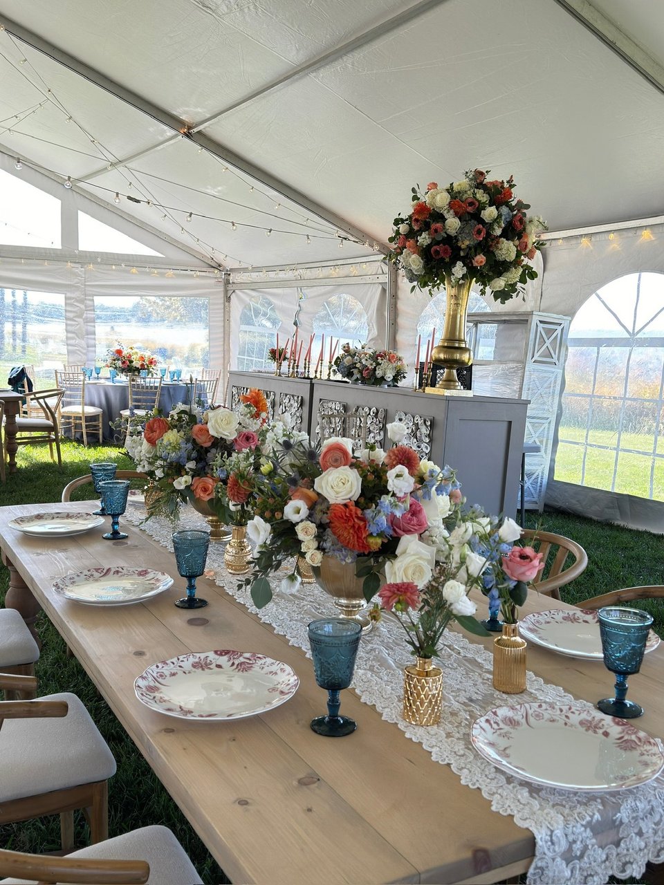 Tent reception table with colorful centerpieces