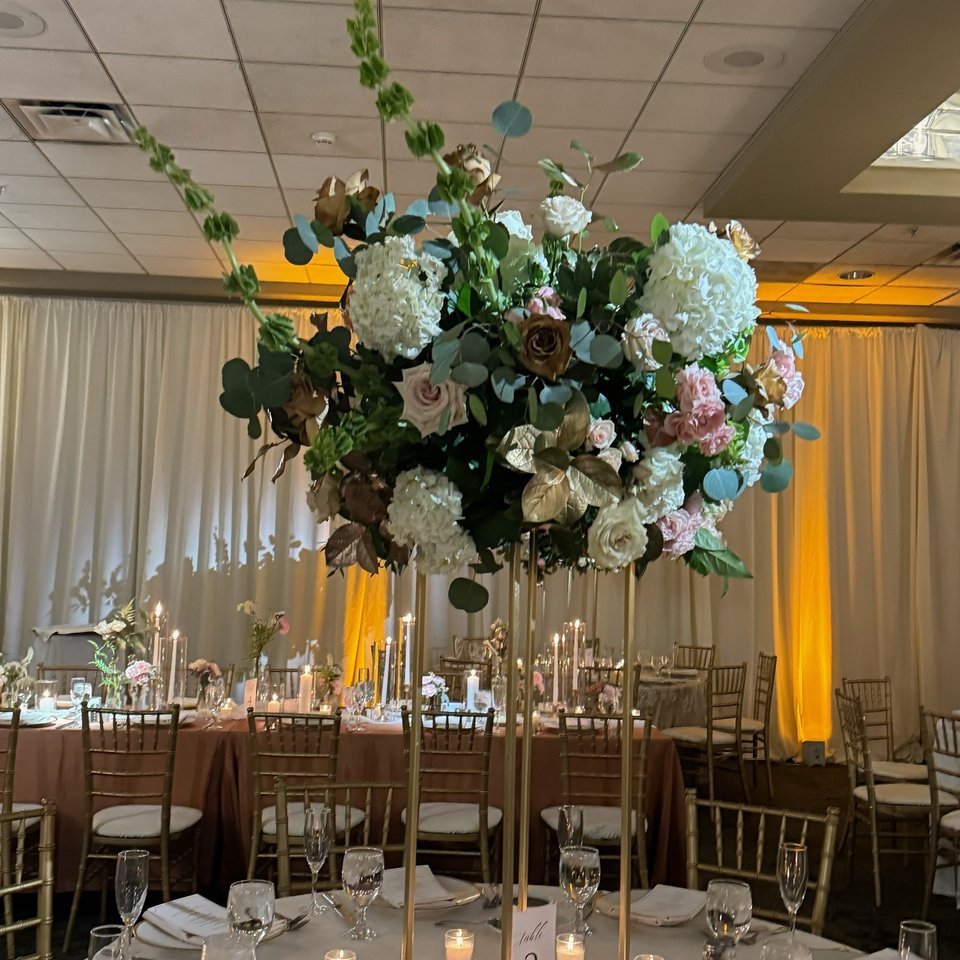 Tall centerpiece over a candlelit reception