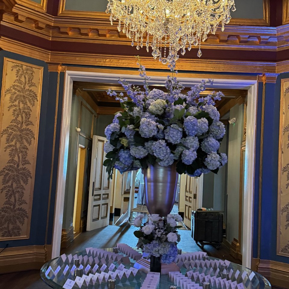 Tall blue hydrangea arrangement in a gilded foyer