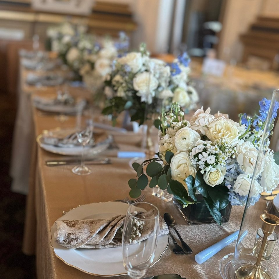 Long reception table with white and blue centerpieces