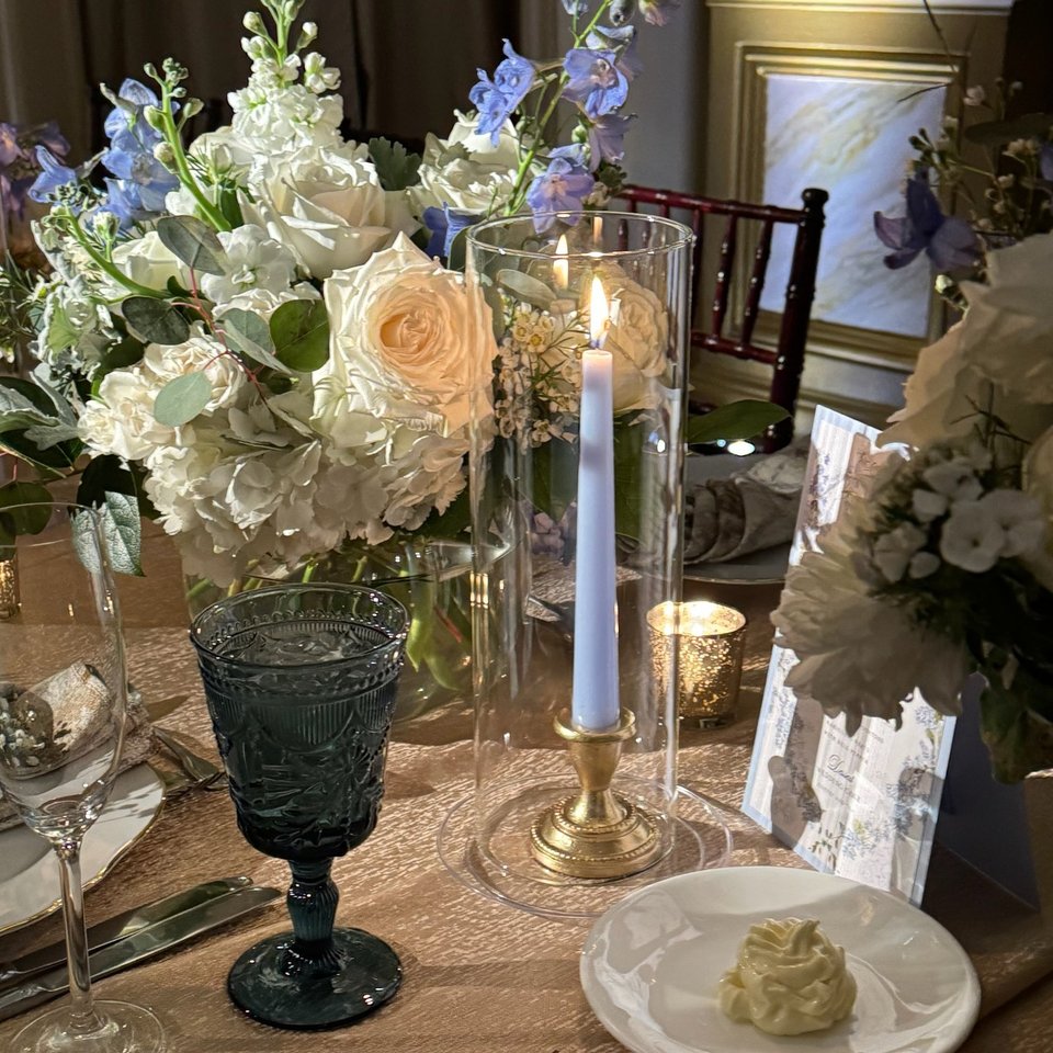 Candlelit reception table with white and blue florals